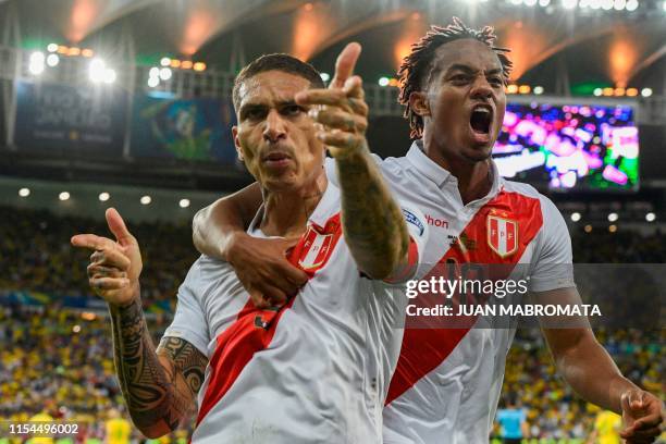 Peru's Paolo Guerrero celebrates with teammate Peru's Andre Carrillo after scoring against Brazil during the Copa America football tournament final...