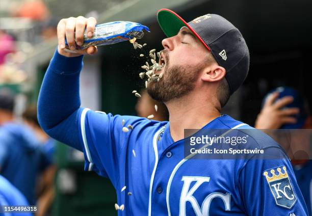 Kansas City Royals catcher Cam Gallagher pours sunflower seeds into his mouth prior to the game between the Kansas City Royals and the Washington...