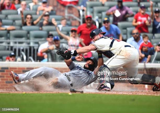 Jorge Alfaro of the Miami Marlins is tagged out at home during the ninth inning by Brian McCann of the Atlanta Braves at SunTrust Park on July 7,...