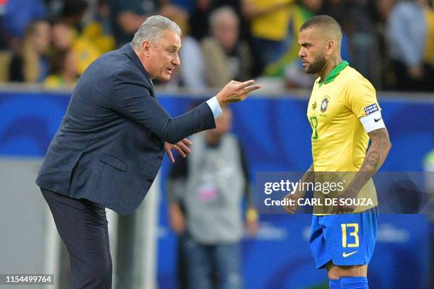 Brazil's coach Tite gives instructions to defender Dani Alves during the Copa America football tournament final match against Peru at Maracana...