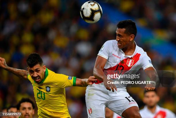 Brazil's Roberto Firmino and Peru's Renato Tapia vie for the ball during their Copa America football tournament final match at Maracana Stadium in...