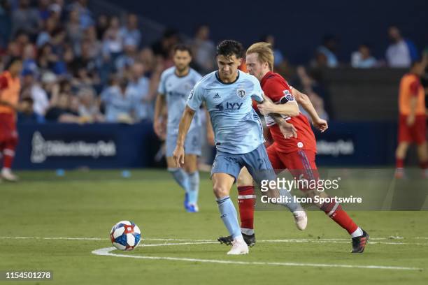Sporting Kansas City midfielder Felipe Gutierrez is fouled by Chicago Fire midfielder Dax McCarty in the second half of an MLS match between the...