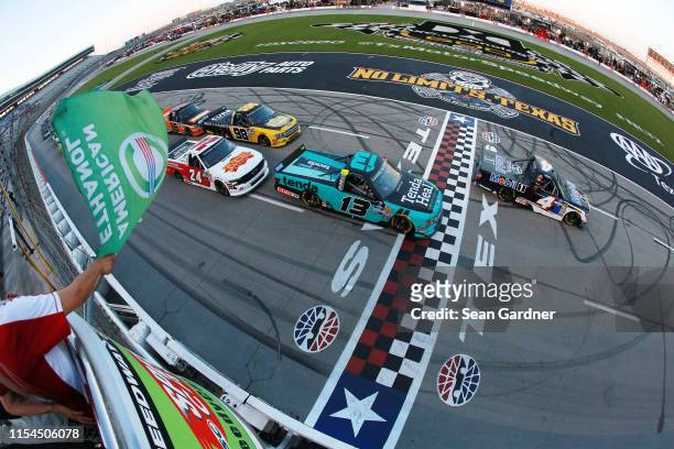 Todd Gilliland, driver of the Mobil 1 Toyota, leads the field at the start of the NASCAR Gander Outdoors Truck Series SpeedyCash.com 400 at Texas...