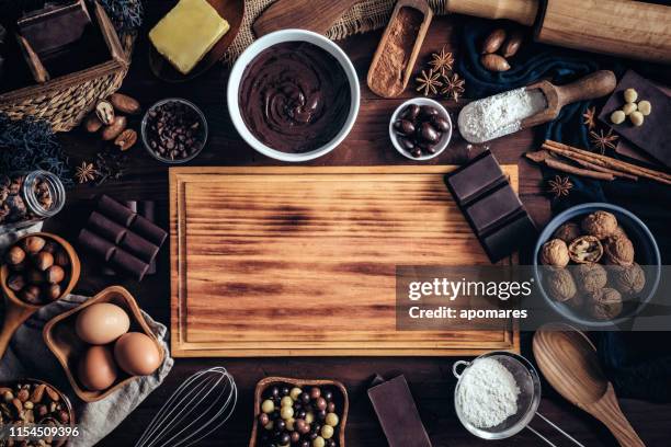 making chocolate mousse and ingredients around a cutting board frame on a wooden table rustic kitchen - chopping block flour stock pictures, royalty-free photos & images