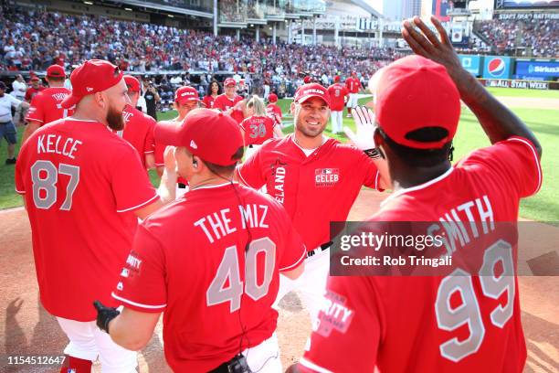 Travis Hafner is congratulated by his Cleveland teammates during the Legends & Celebrity Softball Game at Progressive Field on Sunday, July 7, 2019...