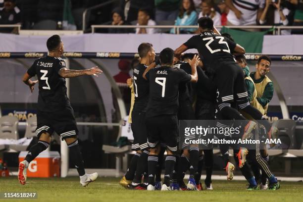 Jonathan dos Santos of Mexico celebrates with his teammates after scoring a goal to make it 1-0 during the 2019 CONCACAF Gold Cup Final between...