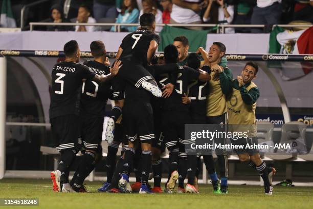 Jonathan dos Santos of Mexico celebrates with his teammates after scoring a goal to make it 1-0 during the 2019 CONCACAF Gold Cup Final between...