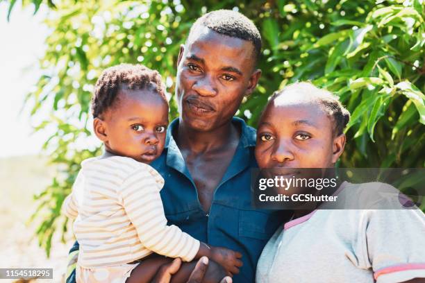 young village couple with their baby girl - zambia woman stock pictures, royalty-free photos & images