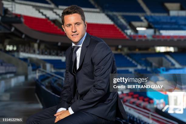 Spanish midfielder Ander Herrera poses after he signed a five-year contract with the Paris Saint-Germain football club at the Parc des Princes, in...