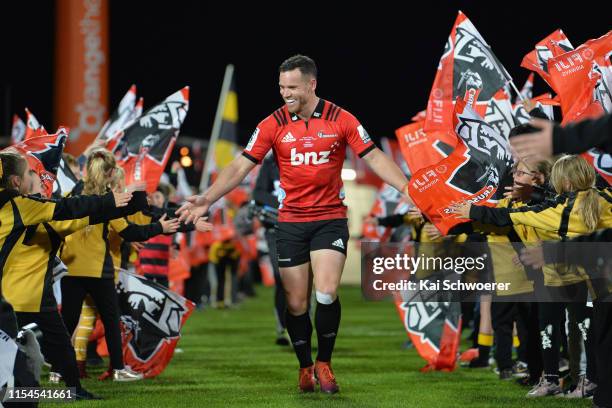 Ryan Crotty of the Crusaders runs out for his 150th Super Rugby match during the round 17 Super Rugby match between the Crusaders and the Rebels at...