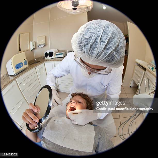 teenage boy looking at teeth during check up - マスキング効果 ストックフォトと画像