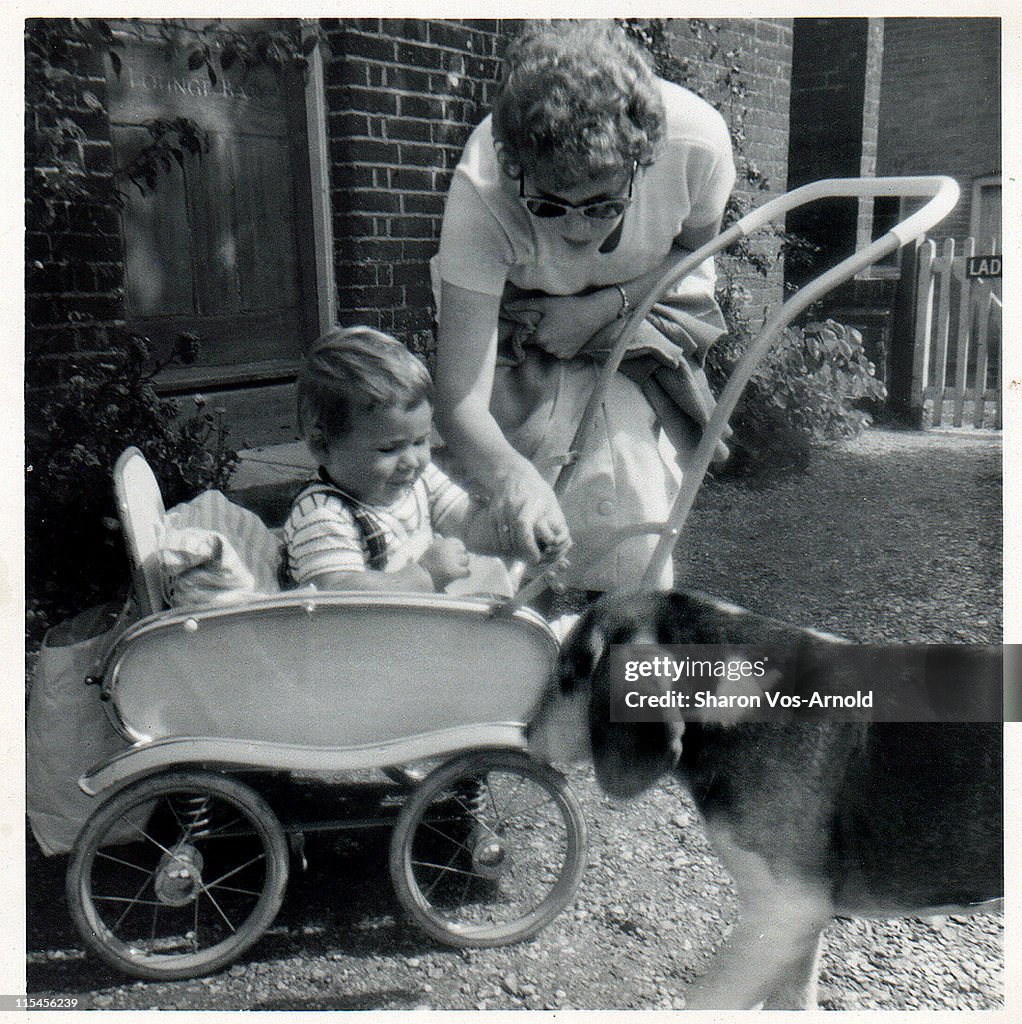 Baby boy in pushchair with his mother