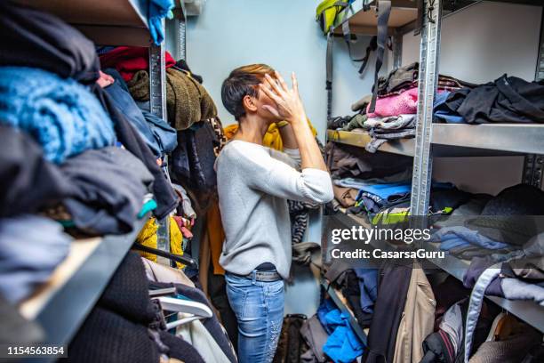 confused mother searching for clothes. - bulges stock pictures, royalty-free photos & images