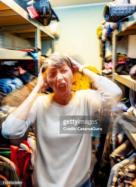 shouting stressed adult woman in a messy wardrobe - overflowing closet stock pictures, royalty-free photos & images