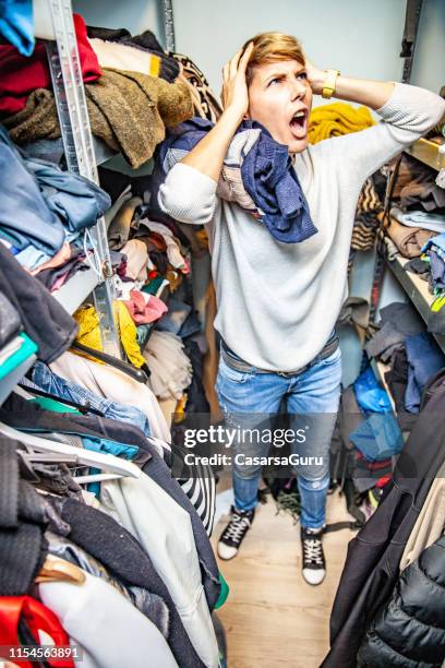 stressed adult woman having a breakdown in the messy closet chaos - overflowing stock pictures, royalty-free photos & images