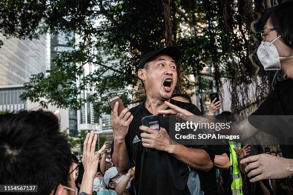 A man discuss with a group of protesters who disapproved and...
