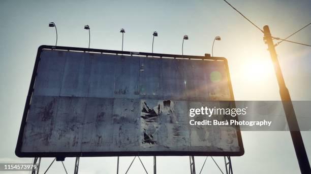 empty billboard against blue sky with telephone pole - weathered filter stock pictures, royalty-free photos & images