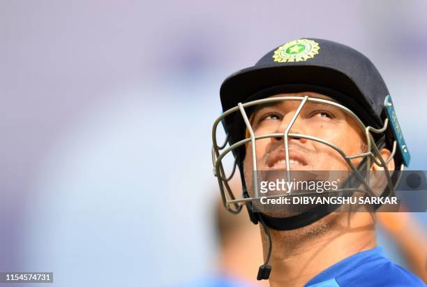 India's Mahendra Singh Dhoni looks on after a session in the nets as he takes part in a training session at Old Trafford in Manchester, north-west...