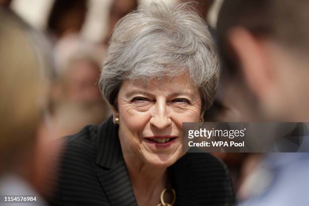Britain's outgoing Prime Minister Theresa May meets military service personnel and their families at headquarters of Joint Forces Command on July 8,...