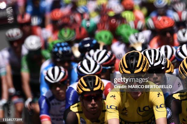 Dutch rider Mike Teunissen, wearing the overall leader's yellow jersey cycles in the pack during the third stage of the 106th edition of the Tour de...