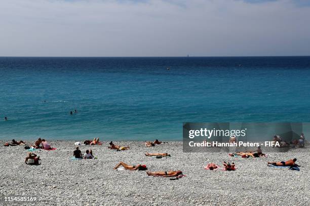 People sunbath at Promenade des Anglais beach ahead of the Fifa Women's World Cup on June 08, 2019 in Nice, France.