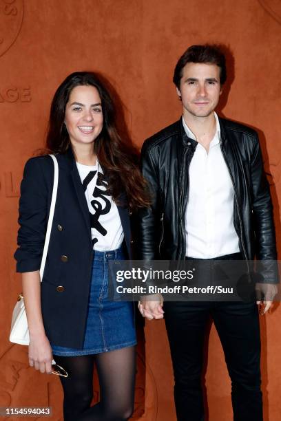 Anouchka Delon and Julien Dereims attend the 2019 French Tennis Open - Day Fourteen at Roland Garros on June 08, 2019 in Paris, France.