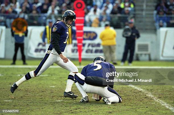 Kicker Matt Stover of the Baltimore Ravens kicks a field goal with Punter Kyle Richardson holding the ball for him in a NFL game against the...