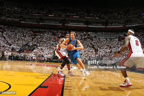 Dirk Nowitzki of the Dallas Mavericks drives to the basket to take the game winning layup against Chris Bosh of the Miami Heat during Game Two of the...