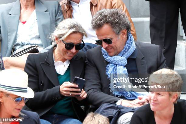 Anne-Sophie Lapix and her husband Arthur Sadoun attend the 2019 French Tennis Open - Day Fourteen at Roland Garros on June 08, 2019 in Paris, France.