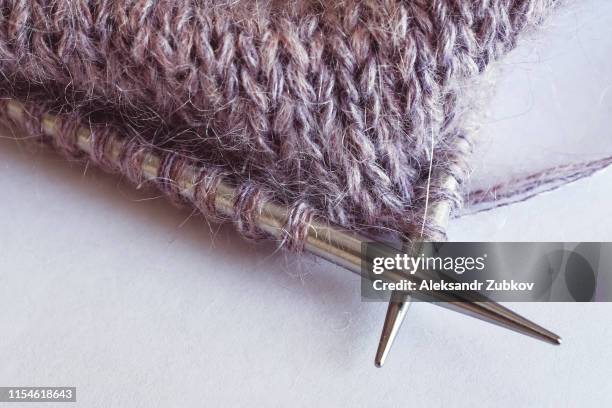 incomplete knitting project with metal needles close-up - ball of wool stock pictures, royalty-free photos & images