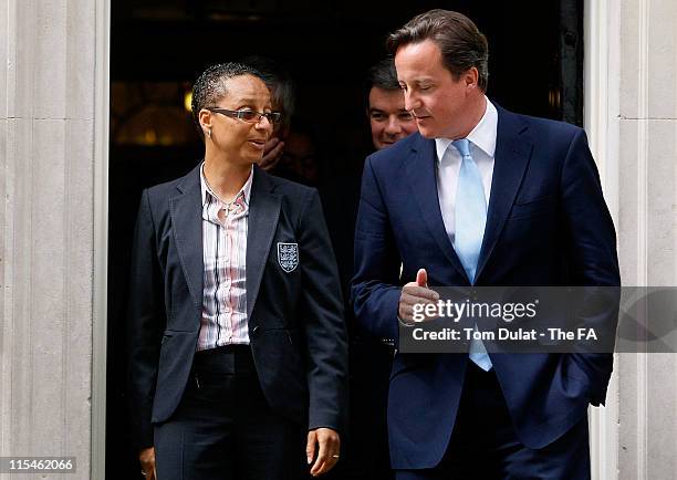 British Prime Minister David Cameron speaks to the England women's national football team coach Hope Powell, ahead of their trip to World Cup in...