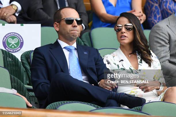 Spanish golfer Sergio Garcia and his wife Angela Akins watch Spain's Rafael Nadal playing Portugal's Joao Sousa during their men's singles fourth...