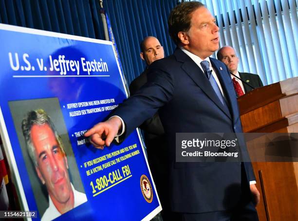 Geoffrey Berman, U.S. Attorney for the Southern District of New York, speaks while standing next to a poster displaying the image of fund manager...