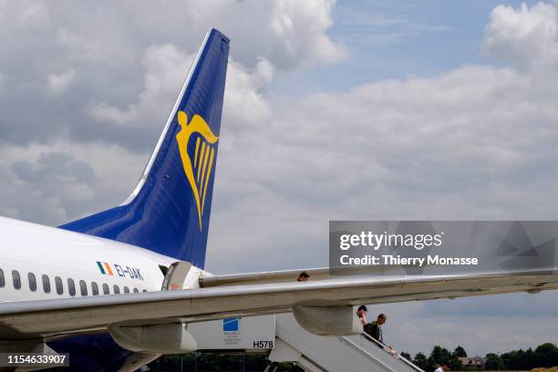 Passengers disembark of a Boeing 737-8AS in Brussels-Charleroi Airport, on July 8, 2019. Ryanair DAC is a low-cost Irish airline founded in 1984 with...