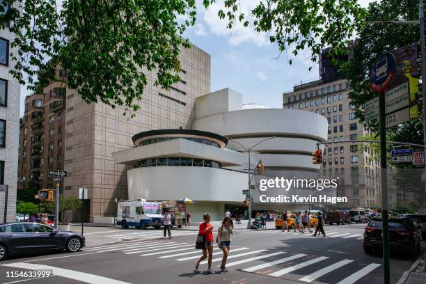 People pass the Solomon R. Guggenheim Museum on July 8, 2019 in New York City. Designed by architect Frank Lloyd Wright, UNESCO has named the...