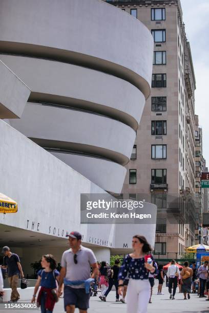 People pass the Solomon R. Guggenheim Museum on July 8, 2019 in New York City. Designed by architect Frank Lloyd Wright, UNESCO has named the...