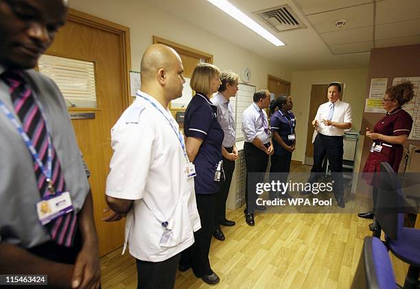 Prime Minister David Cameron speaks to staff on a ward at University College Hospital, before making a speech about NHS reforms there on June 7, 2011...