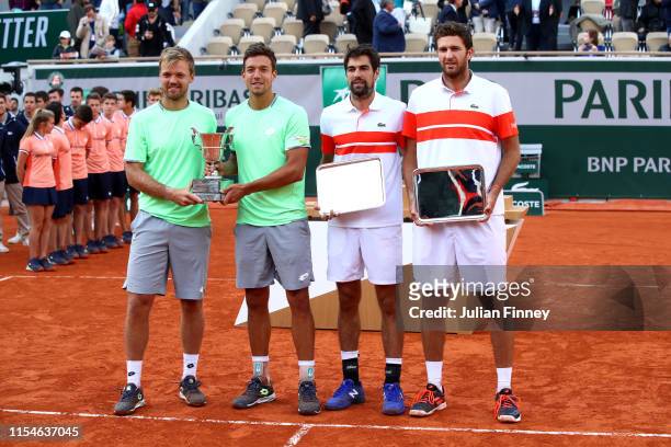 Winners, Kevin Krawietz of Germany and partner Andreas Mies of Germany stand next to runners up Jeremy Chardy of France and Fabrice Martin of France...