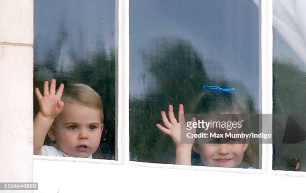 Prince Louis of Cambridge and Princess Charlotte of Cambridge wave from a window of Buckingham Palace as they attend Trooping The Colour, the Queen's...
