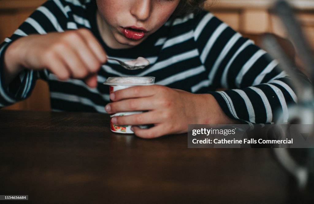 Boy eating Yogurt