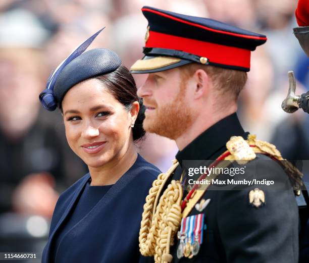 Meghan, Duchess of Sussex and Prince Harry, Duke of Sussex travel down The Mall in a horse drawn carriage during Trooping The Colour, the Queen's...