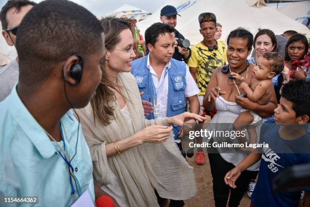 United Nations High Commissioner for Refugees Special Envoy Angelina Jolie greets refugees during her visit to a refugee camp in the border between...