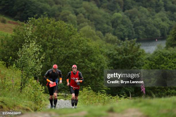 Athletes compete in the Great North Swim Run endurance race at Lake Windermere on June 08, 2019 in Ambleside, United Kingdom. The Great