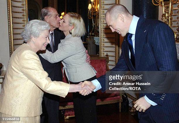 Prince Philip, Duke of Edinburgh kisses his granddaughter, Zara Phillips, as boyfriend, English rugby player Mike Tindall, shakes hands with Queen...