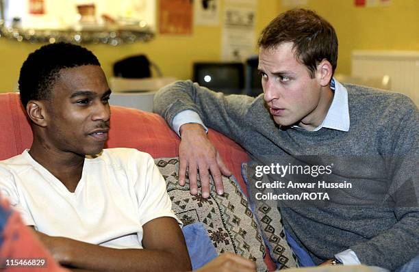 Prince William talks with a young homeless person at a Centrepoint homeless hostel in London during his visit to the centre on December 20, 2006....