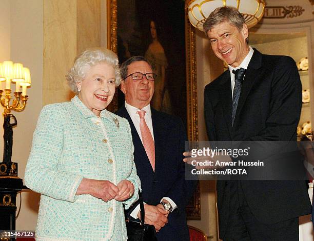 Queen Elizabeth II meets Arsenal chairman Peter Hill-Wood and manager Arsene Wenger at Buckingham Palace on February 15, 2007.