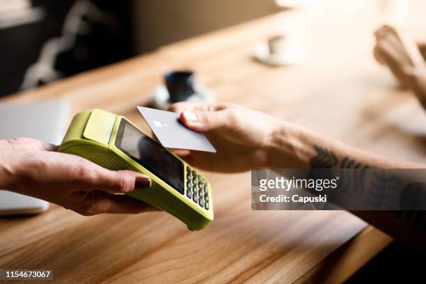 betalen van de rekening met contactloze creditcard - card reader stockfoto's en -beelden