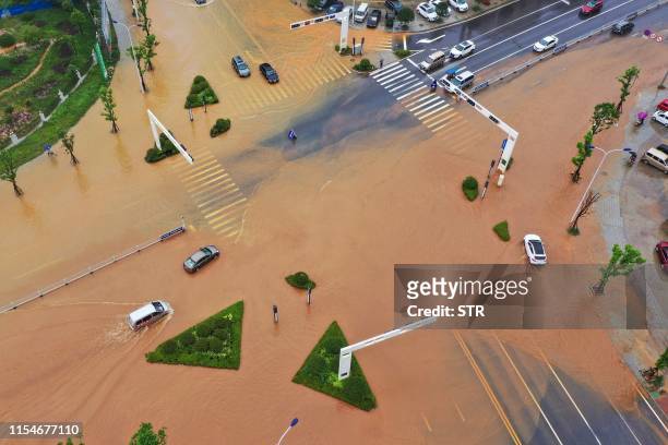 This aerial picture taken on July 9, 2019 shows submerged streets after heavy rain caused flooding in Hengyang in central China's Hunan province. /...