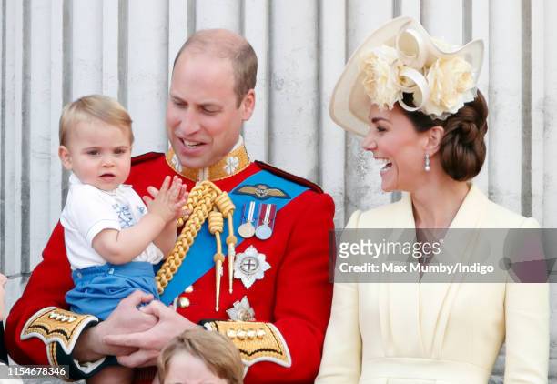Prince William, Duke of Cambridge, Catherine, Duchess of Cambridge and Prince Louis of Cambridge stand on the balcony of Buckingham Palace during...