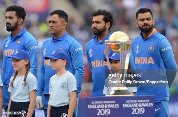 Virat Kohli of India looks on standing near the trophy before the ICC Cricket World Cup Semi Final Match between India and New Zealand at Old...